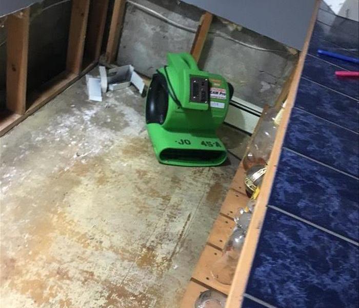 Air mover behind a bar with partial demolition of walls and floor removal