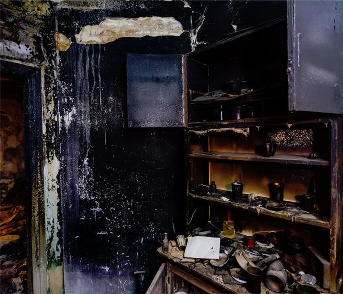 a fire damaged room with soot covering everything
