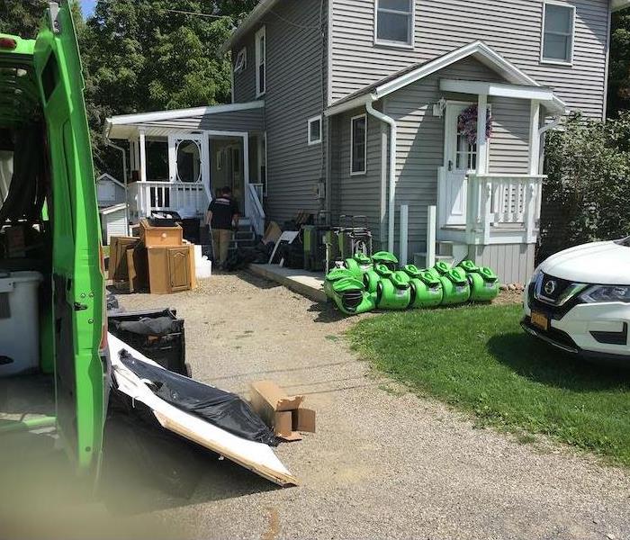 Servpro vehicles and equipment outside of home