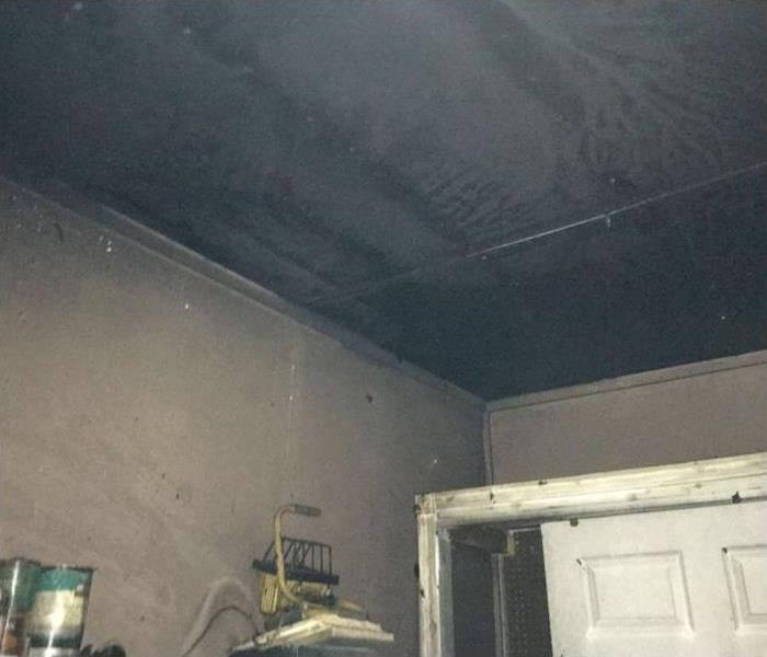 room with blackened ceiling from fire damage