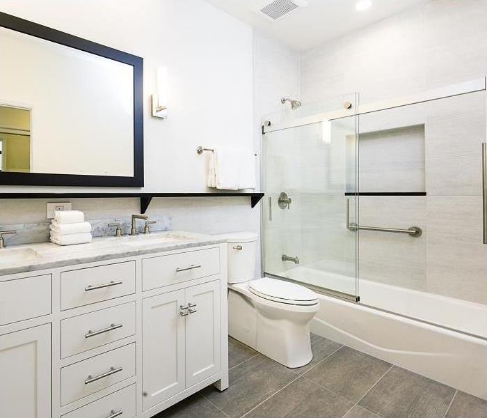 Inside view of bathroom; vanity, toilet, and tub