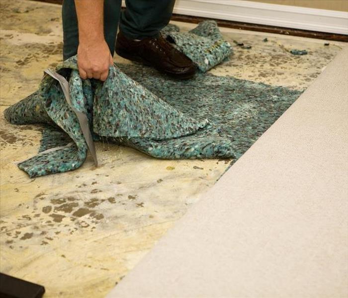 water damaged carpet being removed