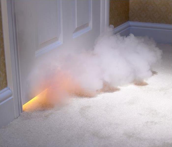 smoke entering room from under door; blaze also seen under door